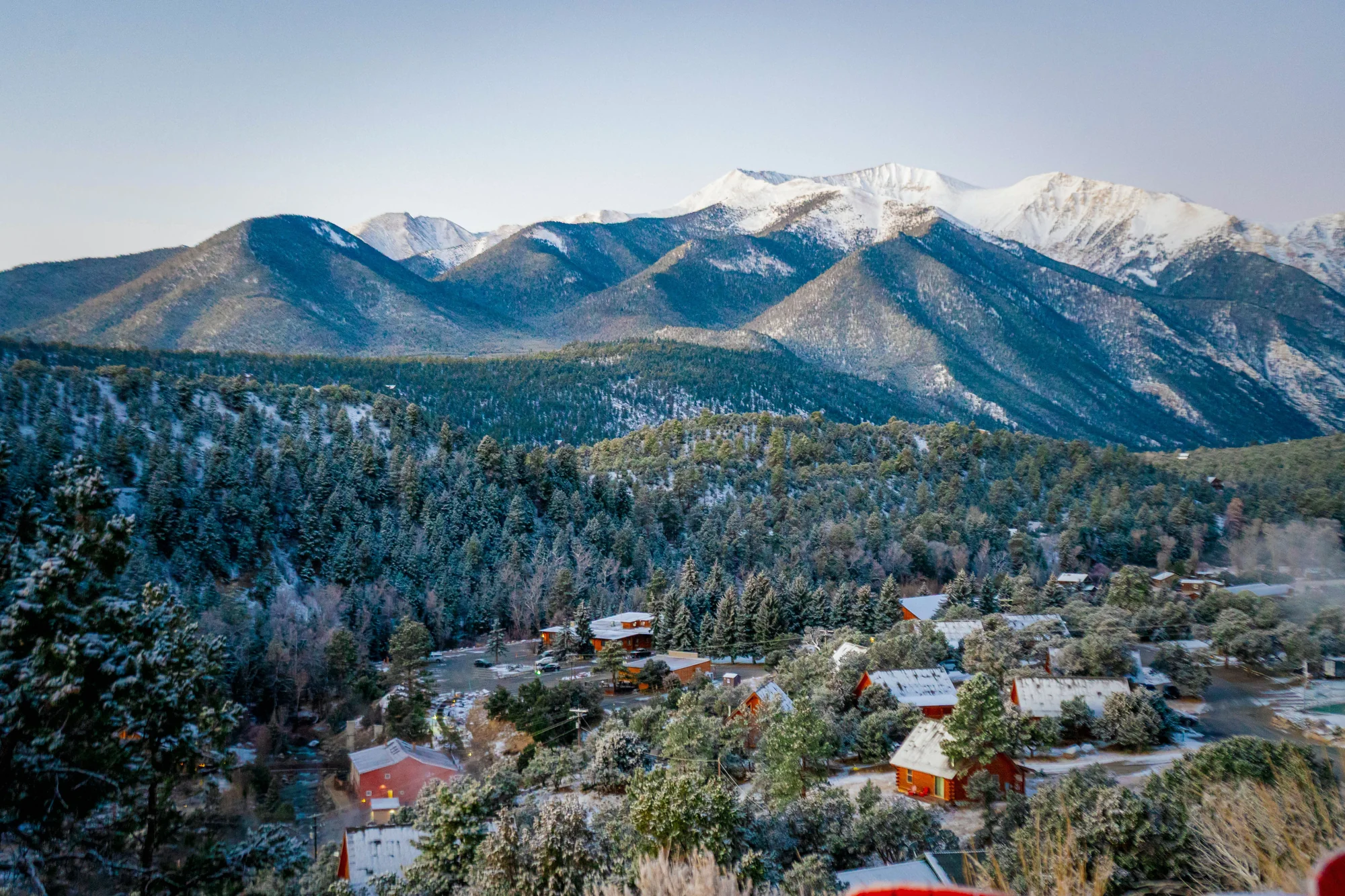 Snow-dusted mountains, pine forest and scattered cabins in Buena Vista, Colorado